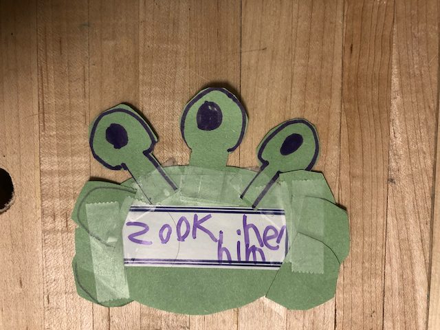 Zook, a round green alien with three eye-stalks.